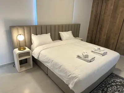 a bed with two towels and a lamp on it at 201 Lux Suite Tower206 in Lakatamia