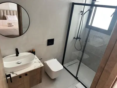 a bathroom with a shower and a toilet and a sink at 201 Lux Suite Tower206 in Lakatamia