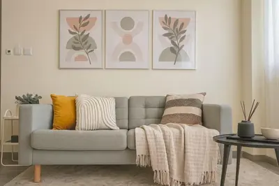 a living room with a couch with pillows and a table at Cozy apartment in Larnaca City Center in Larnaka