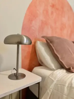 a lamp on a side table next to a couch at Cozy apartment in Larnaca City Center in Larnaka