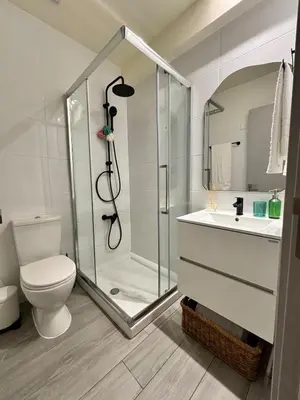 a bathroom with a shower and a toilet and a sink at Cozy apartment in Larnaca City Center in Larnaka
