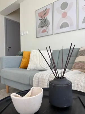 a living room with a couch and a vase on a table at Cozy apartment in Larnaca City Center in Larnaka