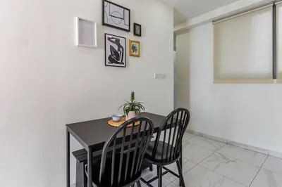 a dining room with a table and two chairs at Best location in Larnaca 100m from the beach in Larnaka