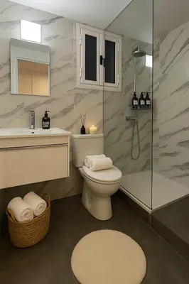a bathroom with a toilet and a shower and a sink at Studio by The Sea in Limassol