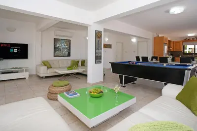 a living room with a pool table and a couch at Villa GreenWay - Large Private Pool in Protaras