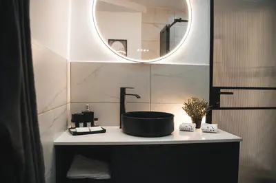 a bathroom with a sink and a mirror at Kition Urban Suite 3 in Larnaka