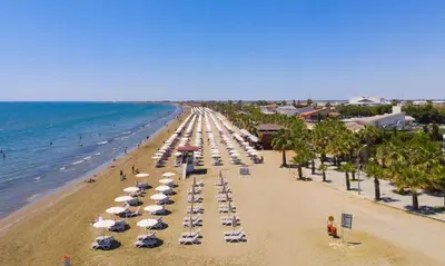 an overhead view of a beach with umbrellas and the ocean at Mackenzie Beach Apartment in Larnaka