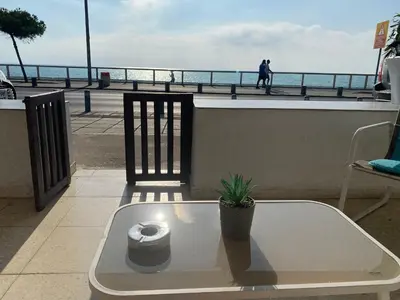 a bench with a roll of toilet paper on a balcony at Mackenzie By the sea one bed Ground floor home in Larnaka