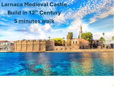 a poster of a building next to a body of water at Mackenzie By the sea one bed Ground floor home in Larnaka