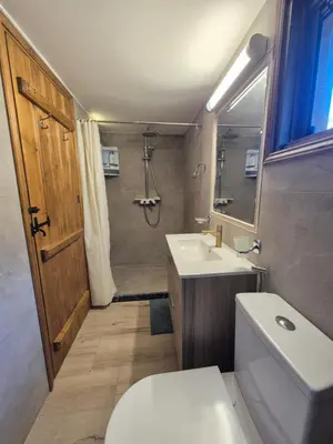 a bathroom with a toilet and a sink and a mirror at Cozy Paradise in Pedoulas