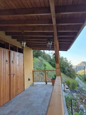 a porch of a house with a wooden deck at Cozy Paradise in Pedoulas