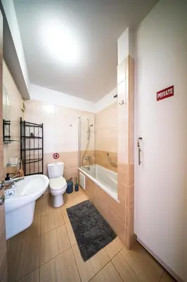 a bathroom with a tub and a toilet and a sink at Chromata Lagoon Sea View Apartment in Paralimni