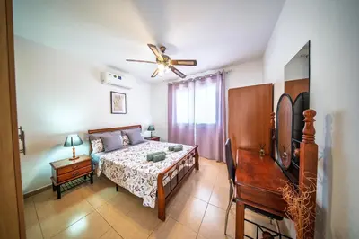 a bedroom with a bed and a ceiling fan at Chromata Lagoon Sea View Apartment in Paralimni