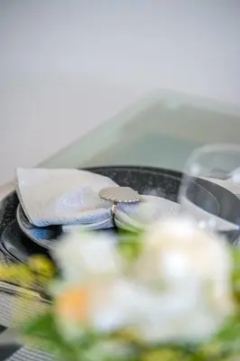 a bow tie sitting on top of a plate with food at Chromata Lagoon Sea View Apartment in Paralimni
