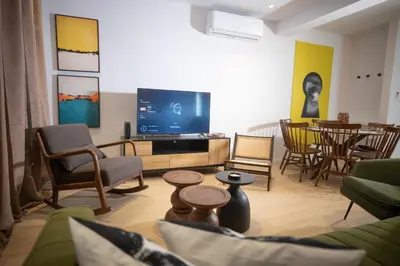 a living room with a couch and a tv at Vivid Stays Chalkokondili in Nicosia