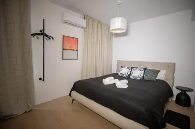 a bedroom with a bed with two slippers on it at Vivid Stays Chalkokondili in Nicosia