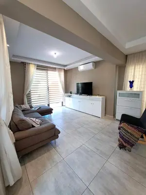 a living room with a couch and a television at Villa Allamare with a pool in Paralimni