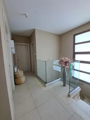 a room with a vase of flowers in a room at Villa Allamare with a pool in Paralimni