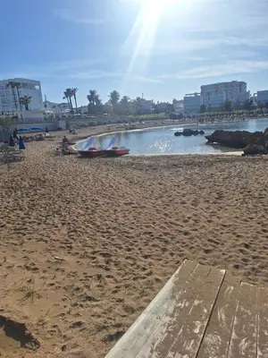 a sandy beach with two boats on the water at Big house in center of protaras, near beach in Protaras