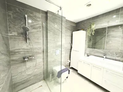 a bathroom with a shower and a toilet and a sink at Wealthystays Duplex in the Heart of Nicosia in Nicosia