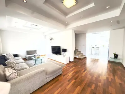 a living room with a couch and a flat screen tv at Wealthystays Duplex in the Heart of Nicosia in Nicosia