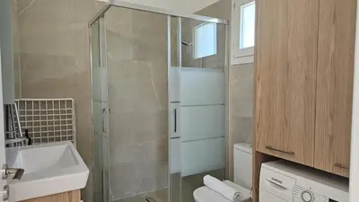 a bathroom with a shower and a toilet and a sink at STAY Sunny Honey Apartment in Ayia Napa