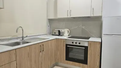 a kitchen with a sink and a stove top oven at STAY Sunny Honey Apartment in Ayia Napa