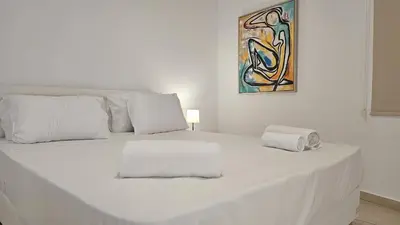 a white bed with two towels on top of it at STAY Sunny Honey Apartment in Ayia Napa
