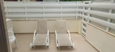 two chairs and two tables on a building at Sea Breeze Maisonette in Larnaka