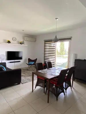 a living room with a wooden table and chairs at Gorgeous 1 Bedroom apartment close to Town Centre in Limassol