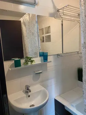 a white bathroom with a sink and a mirror at Gorgeous 1 Bedroom apartment close to Town Centre in Limassol
