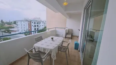 a balcony with a table and chairs on a balcony at STAY Suncity Apartment in Larnaka