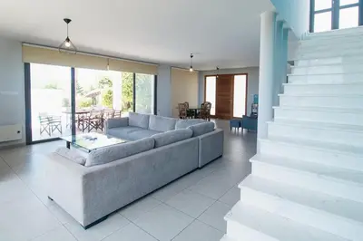 a living room with a couch and a table at Maestro Villa in Meneou