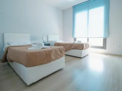 a room with two beds and a window at Maestro Villa in Meneou