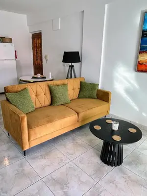 a living room with a couch and a table at Casa Sea Breeze in Larnaka