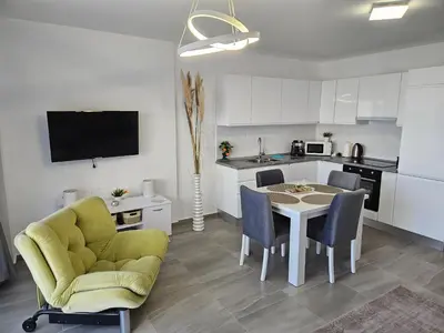 a kitchen and dining room with a table and chairs at Cozy apartment at Thalassa Beach Resort, Northern Cyprus in Paralimni