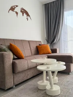 a living room with a couch and a table at Cozy apartment at Thalassa Beach Resort, Northern Cyprus in Paralimni