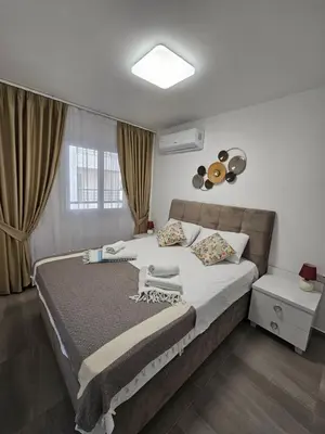 a bedroom with a large bed and a window at Cozy apartment at Thalassa Beach Resort, Northern Cyprus in Paralimni
