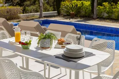 a white table and chairs with a plate of food at Villa Milos 36 in Protaras
