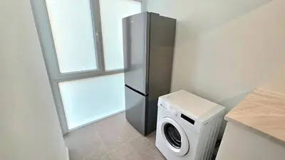 a kitchen with a refrigerator and a washing machine at Kanika 3 bedroom city beach in Limassol