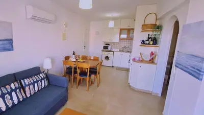 a living room with a blue couch and a table at STAY Camelia Apartment in Larnaka