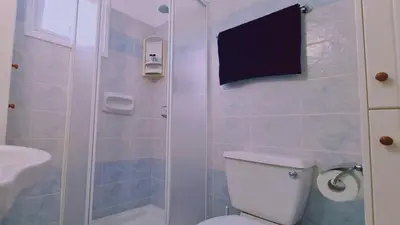 a bathroom with a toilet and a sink and a shower at STAY Camelia Apartment in Larnaka
