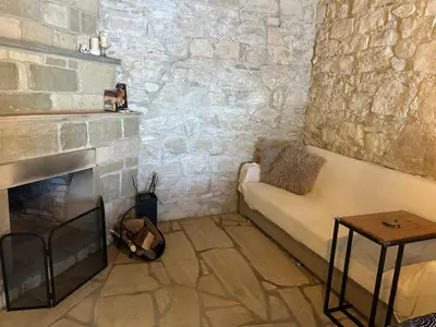 a living room with a couch and a fireplace at The Hideaway in Arminou