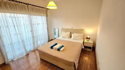 a bedroom with a bed with two pillows on it at Neapolis city apartment in Limassol