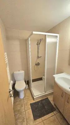 a bathroom with a shower and a toilet and a sink at Neapolis city apartment in Limassol