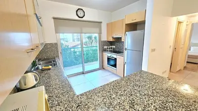a kitchen with a refrigerator and a counter top at Neapolis city apartment in Limassol