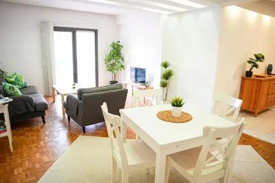 a living room with a white table and chairs at The Cozy Seaside Retreat in Larnaka