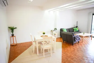 a living room with a table and a couch at The Cozy Seaside Retreat in Larnaka