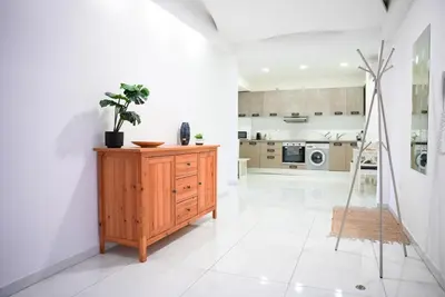 a kitchen with a wooden dresser in a room at The Cozy Seaside Retreat in Larnaka