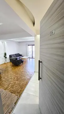 a sliding door in a living room with a couch at The Cozy Seaside Retreat in Larnaka